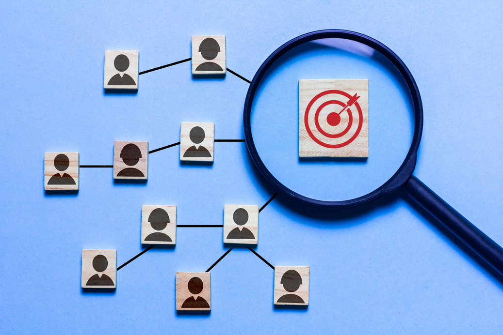 Red dart board icon and white arrow linked with human icon for target group, organizational development concept.